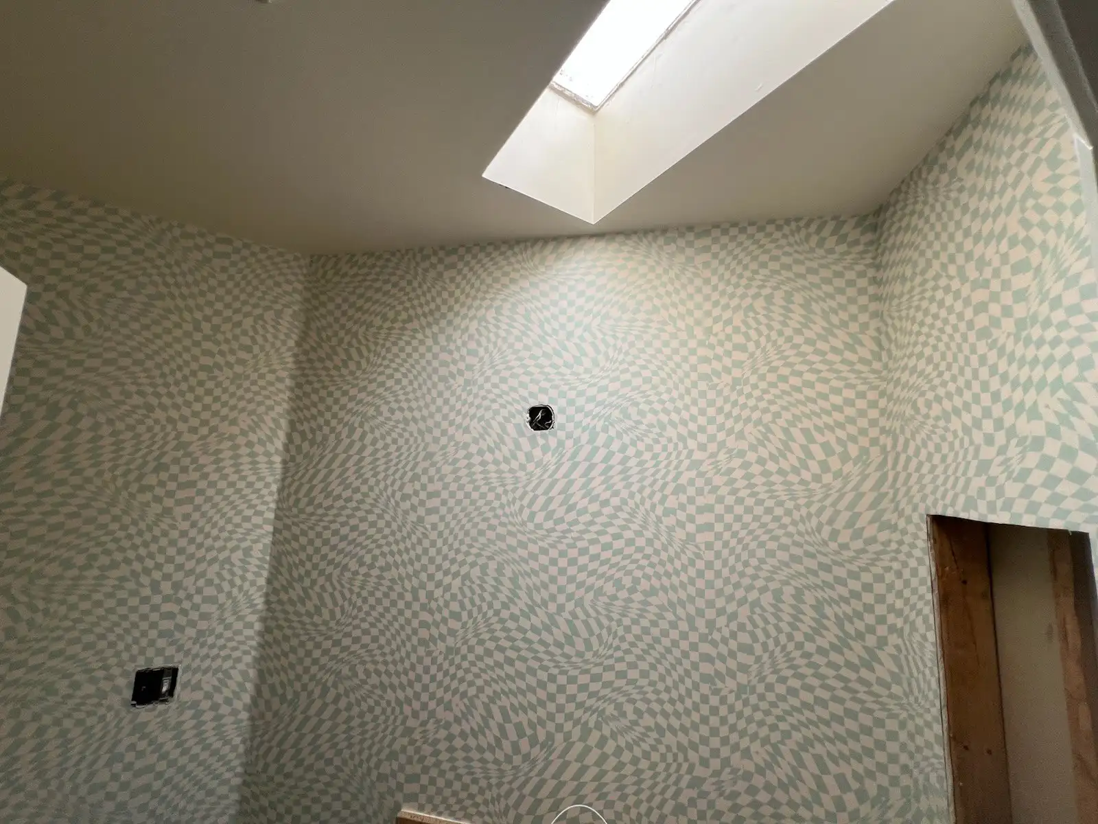 Professional wallpaper installer carefully applying wall covering